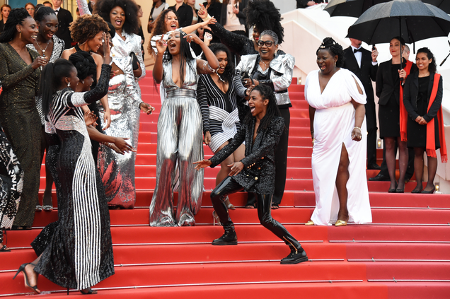 Authors of the book Noire N’est Pas Mon Métier (Black Is Not My Job) dance on the stairs at the screening of Burning during the 71st annual Cannes Film Festival at Palais des Festivals on May 16, 2018, in Cannes, France.